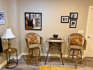 Pub table and chairs behind sofa in main room.