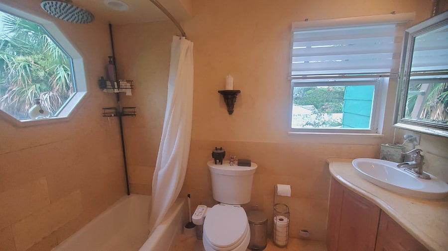 Bright sunny upstairs bathroom with rain shower