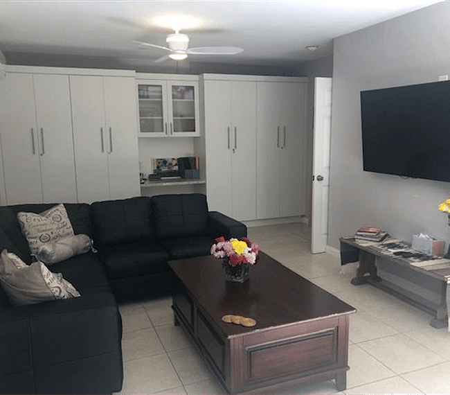 Spacious open living room with sectional L-Type sofa and TV