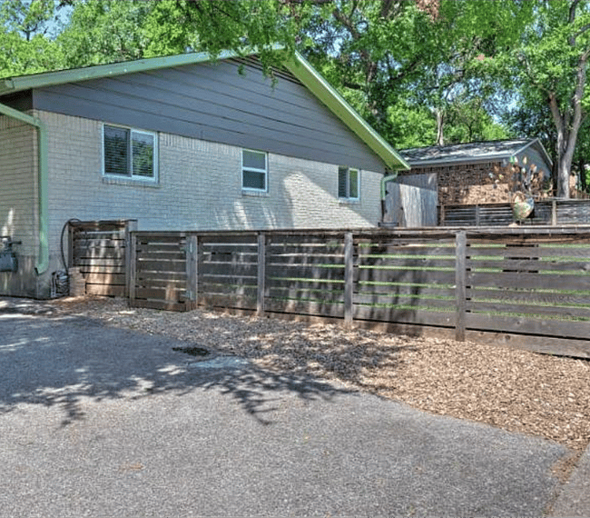 Fenced in front yard maintained by property owner