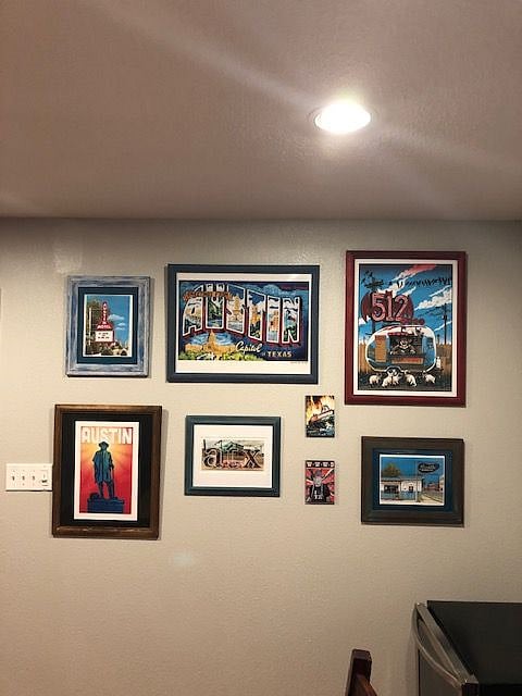 Wall in dining room with artwork by local artists