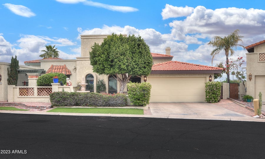 Front of the house with a 2 car garage and private driveway.