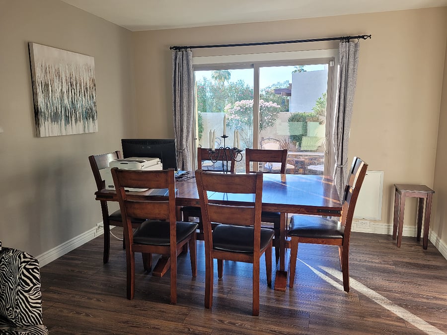 Sunny dining room with slider to outside dining area. Next to the kitchen