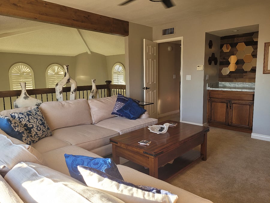 Upstairs cozy TV room with counter area for dry bar and French doors to an upstairs deck. Ve