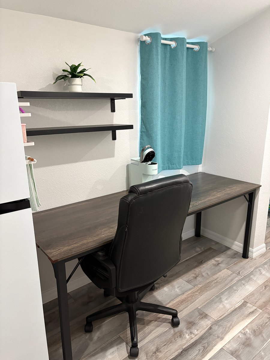 Long desk for area to work and/or eat. Black out window curtain and Keurig coffee maker. 2 floating shelves. 