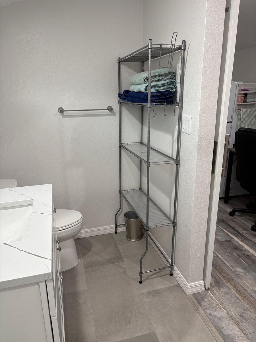 Brand new bathroom remodel, with storage shelf and new vanity with drawers.