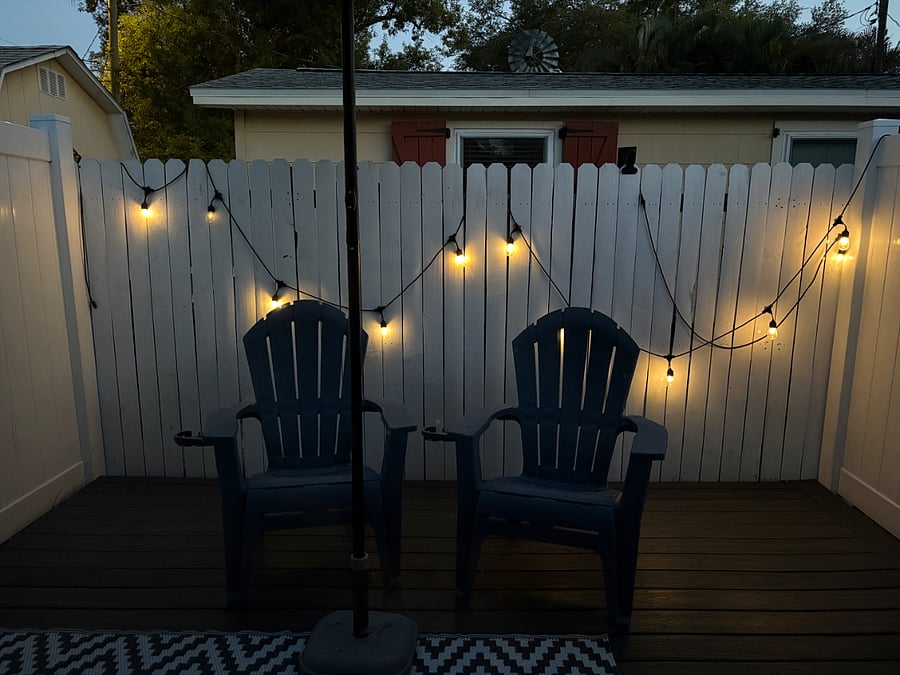 Private, secure patio with 2 chairs, umbrella and bistro lights. 