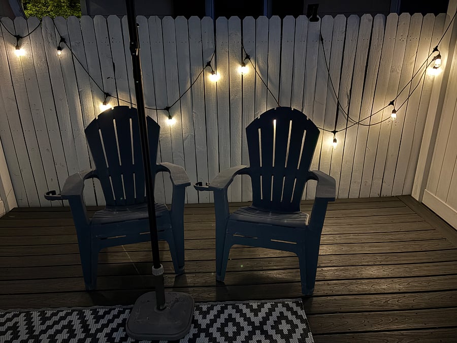 Private, secure patio with 2 chairs, umbrella and bistro lights. 