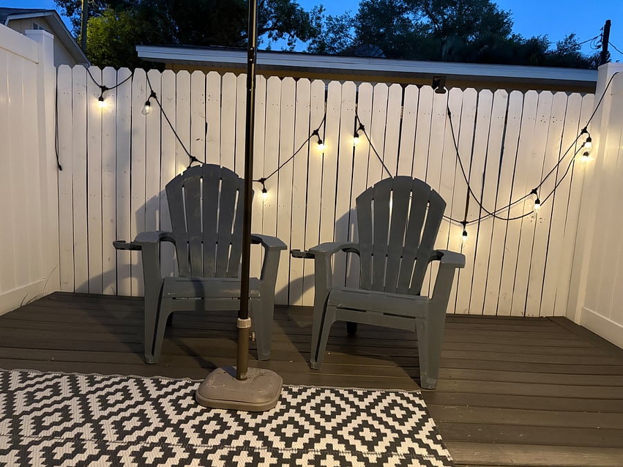 Private, secure patio with 2 chairs, umbrella and bistro lights. 