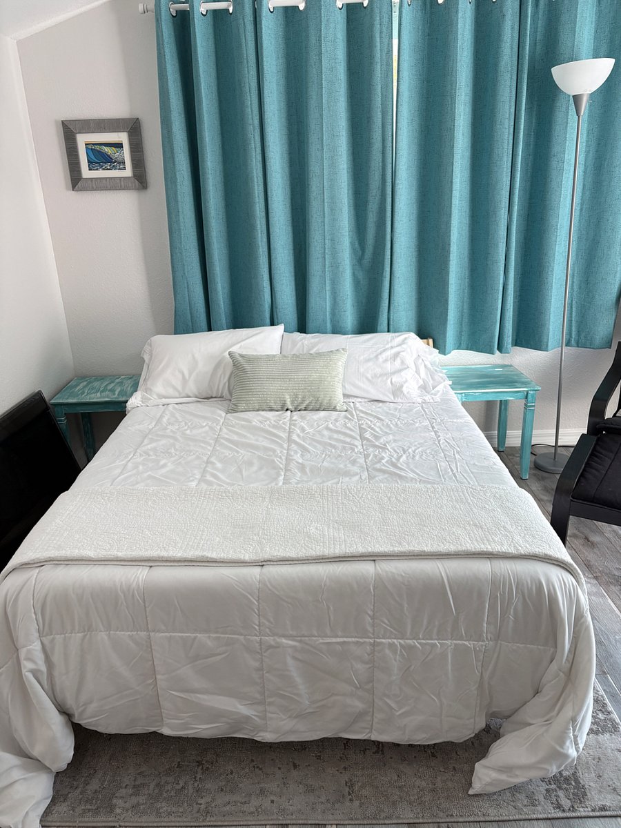 Brand new full sized bed, with 4 pillows, brand new bedding, sheets, comforter and extra blanket. 2 side tables. Lamp next to reclining chair.