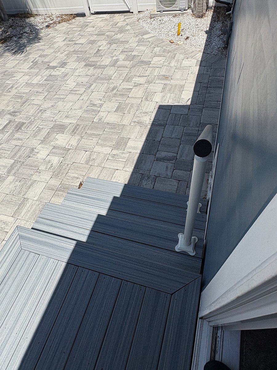 Stairs and handrail leading to sliding door entry from the driveway