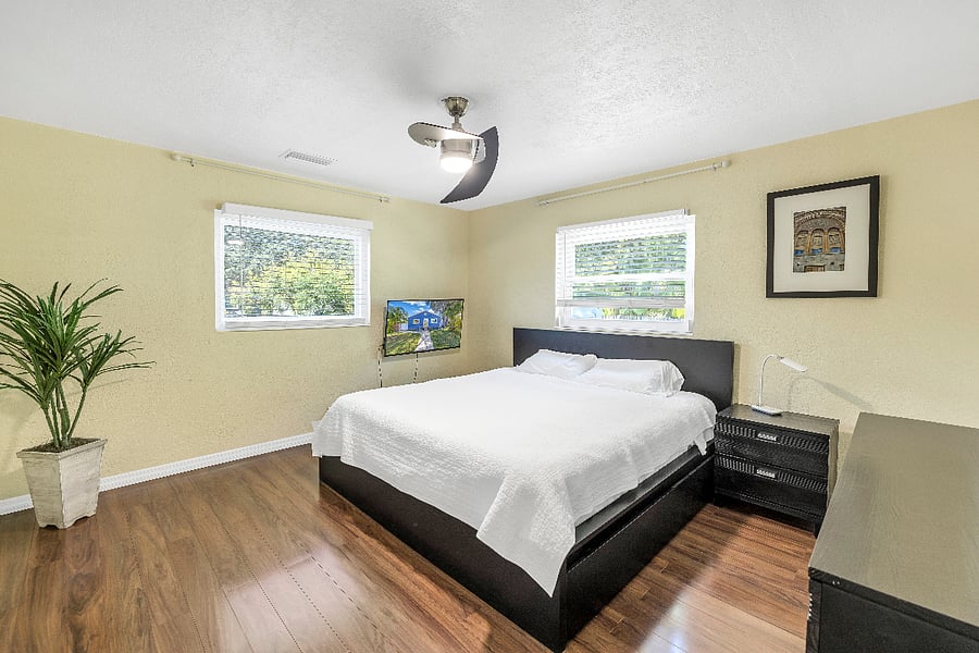 King size bed, 2 XL mattresses. drawers below for storage. Blackout curtains. 32" TCL TV mounted on wall, dresser with 6 drawers