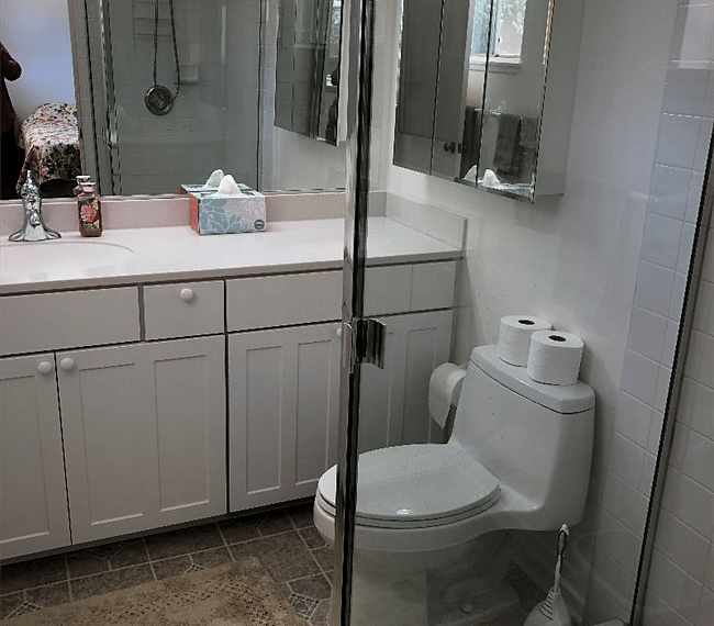 The bathroom is modern and stylish with shower, toilet and vanity