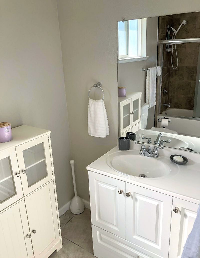The bathroom has plenty of storage space, and of course a full set of towels is provided.