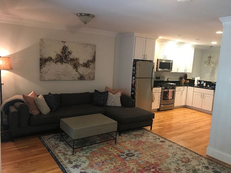 First floor living room with extra long couch & chaise. Kitchen, Living and Dining room are open floorplan.