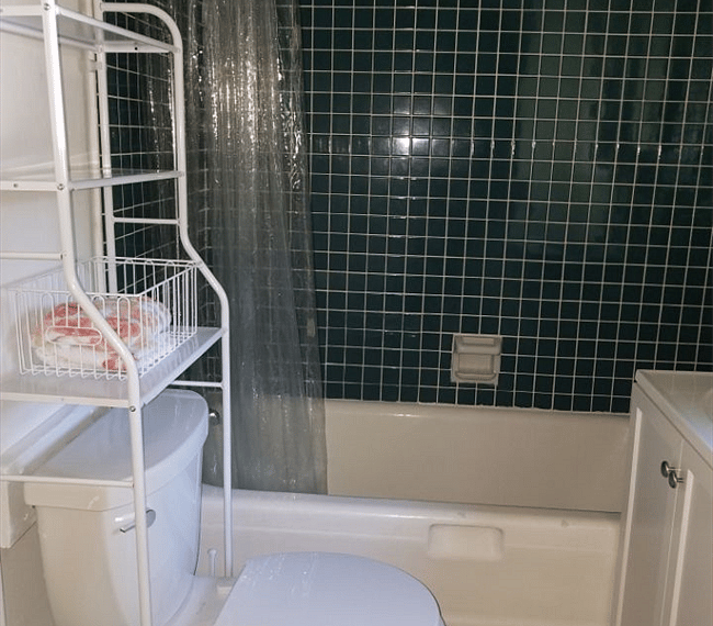 Fully tiled family bathroom with combined bath and shower