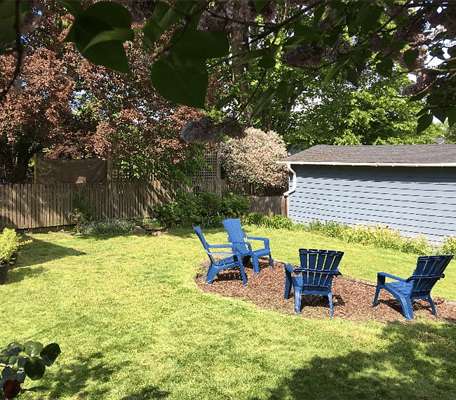 Large back yard; partially fenced; mowed by lawn service.  Enjoy blueberries, raspberries, pears, mint, oregano, thyme, strawberries, roses, peonies, lilacs depending on the time of year!  