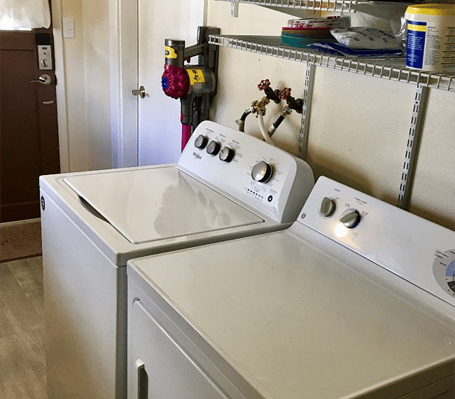 Large utility room with pantry storage and washer/dryer.