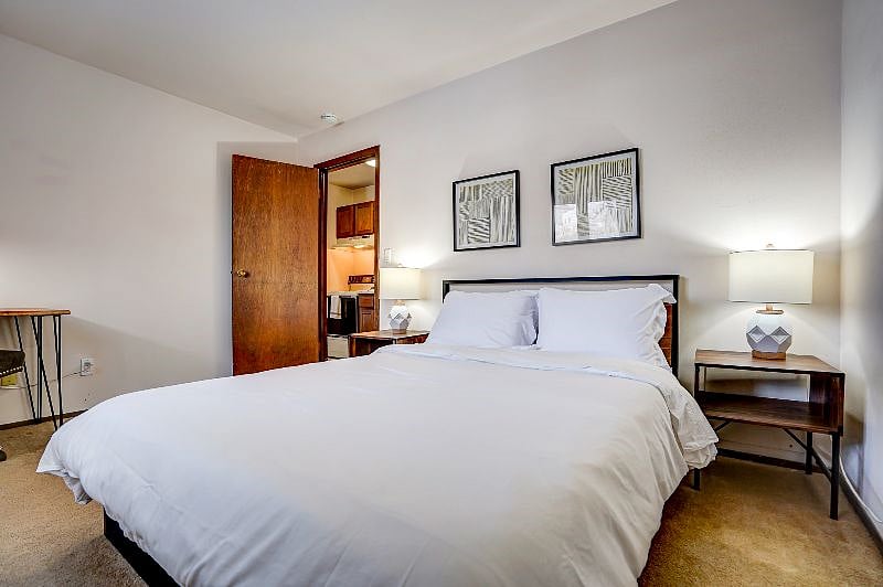 Queen bed with pair of reading lamps and tables. Extra sheets are in the closet!