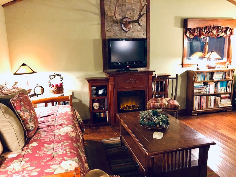 Our mountain lodge decor features vintage accessories, artwork and actual deer antlers just above the fireplace mantle, creating an authentic forest ambiance.