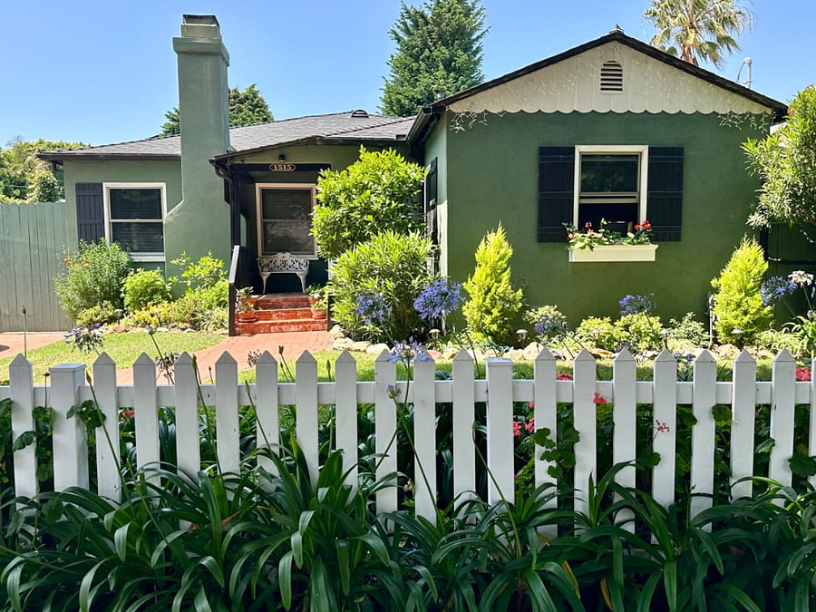 Street view of main house. A cheerful white picket fence, seasonal geraniums and Lillies of the Nile make our location easy to find!