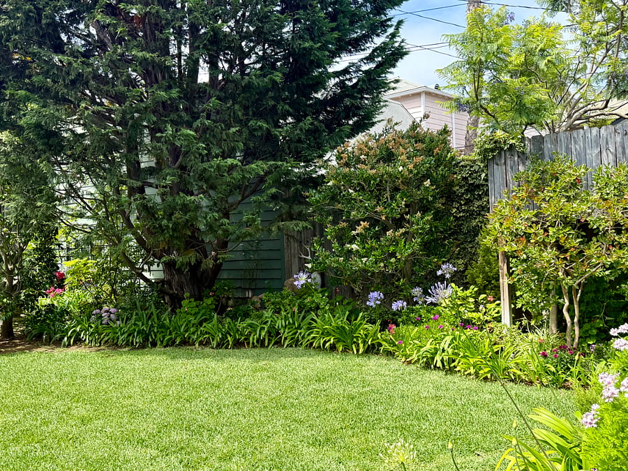 As you fully enter this backyard, the lush lawn, English flower garden and weathered treehouse delight both adult guests and children of all ages!