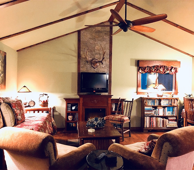 This 400 square foot rustic "craftsman lodge" showcases hardwood floors, base boards and trim, under a vaulted ceiling with a room-size paddle fan.