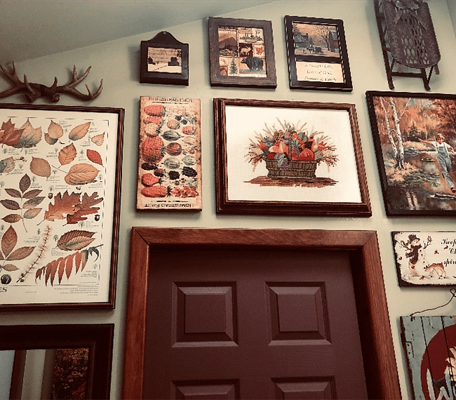 The fourth bathroom wall features an autumn-themed art gallery. This unique visual collection adds a truly personal touch to our Cabin decor!
