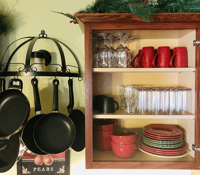 A black wrought-iron rack over the sink holds a variety of pots and pans that are easily accessible and designed for delicious home cooking!