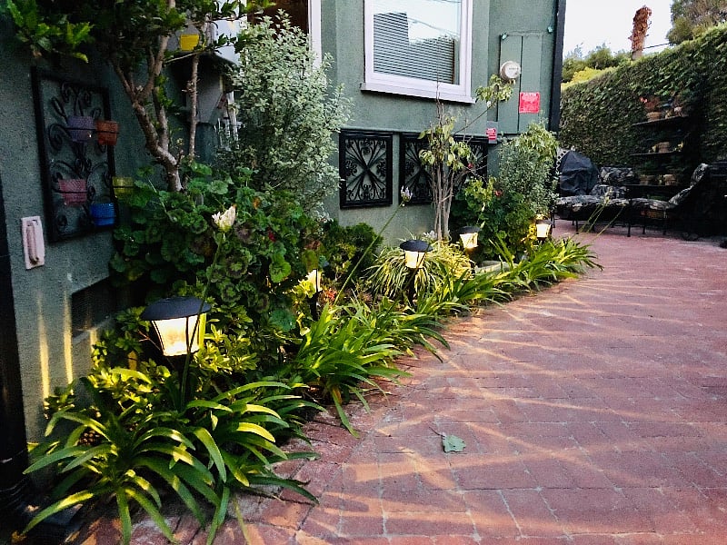 This brick-paved patio walkway, leading from the backyard to the front of our property, has solar lights to illuminate your path in the evenings.
