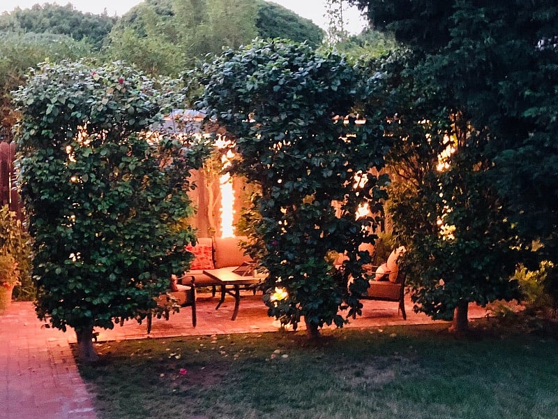 The patio area looks even more beautiful at dusk, with glowing white lights that automatically turn on at twilight for a few hours each evening!