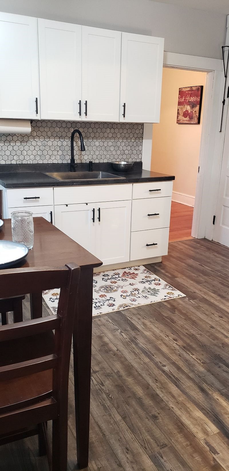 2nd floor kitchen looking into office/rec room. It has a small rowing machine and yoga mat.
Pantry is to left of the counter