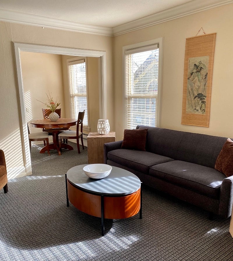 Living Room looking into sunny eating nook 