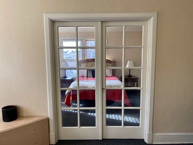 100 yr old French Doors lead into bedroom from Living room 