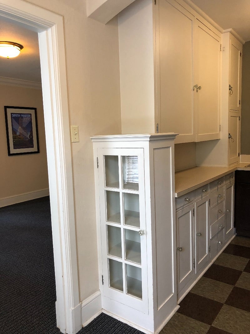 100 year old floor to ceiling cabinetry provides ample storage