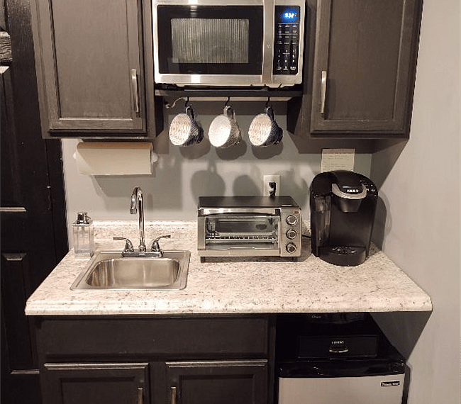 Kitchenette includes hotplate, convection oven, microwave, mini-fridge with freezer, stocked with flatware, dishes, glasses, cookware, cupboard & drawer space.
Keurig Coffeemaker includes a wide variety of coffee flavors, sweeteners, and creamers.