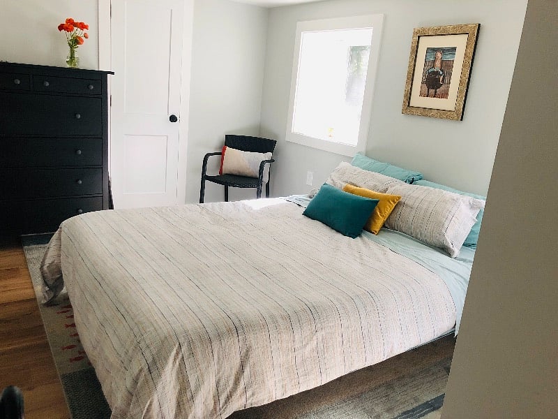 Sweet bedroom with window boxes, a full sized dresser and small closet, and a comfy new queen bed.