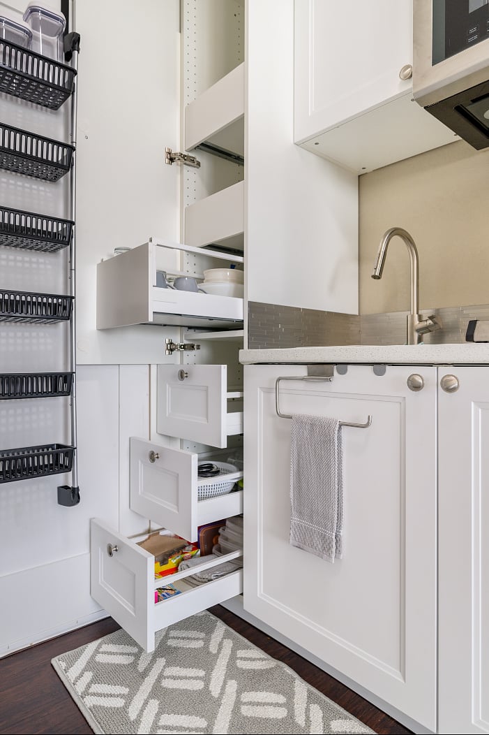 Easy access with pull out shelves & drawers, plenty of storage, and well stocked & appointed kitchenette.