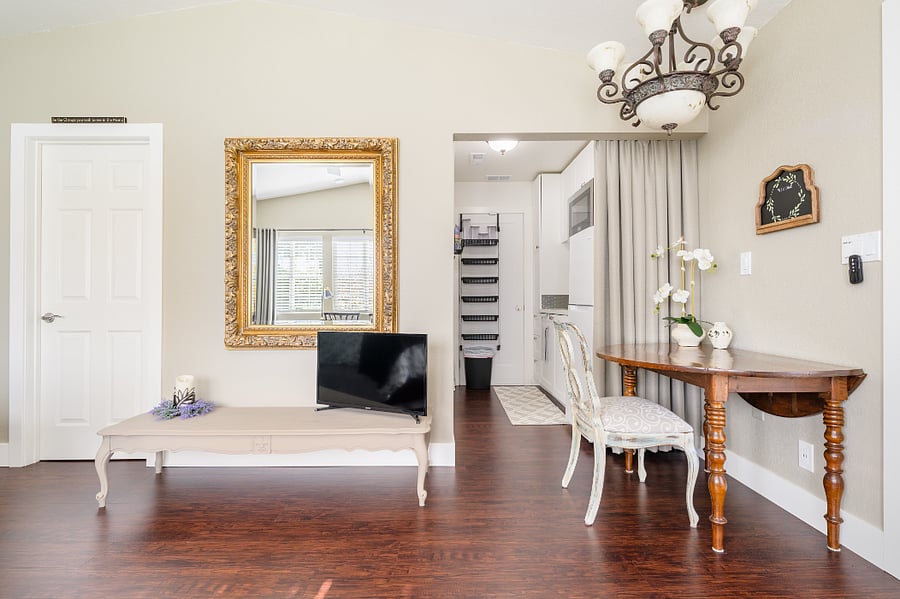Eating area adjoins kitchenette with expandable dining table, beautiful chandalier