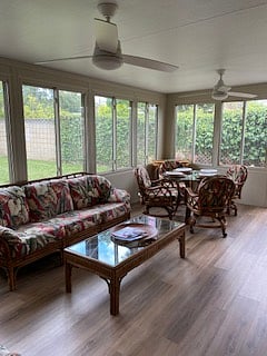Tropical Sunroom dining and seating with lots of board games