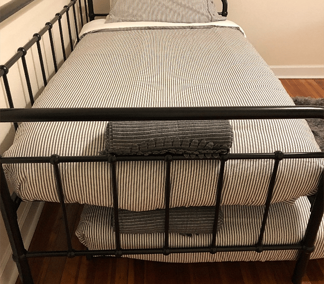 3rd bedroom with 2 single beds (1 is a trundle bed), Roku TV, desk & chair.