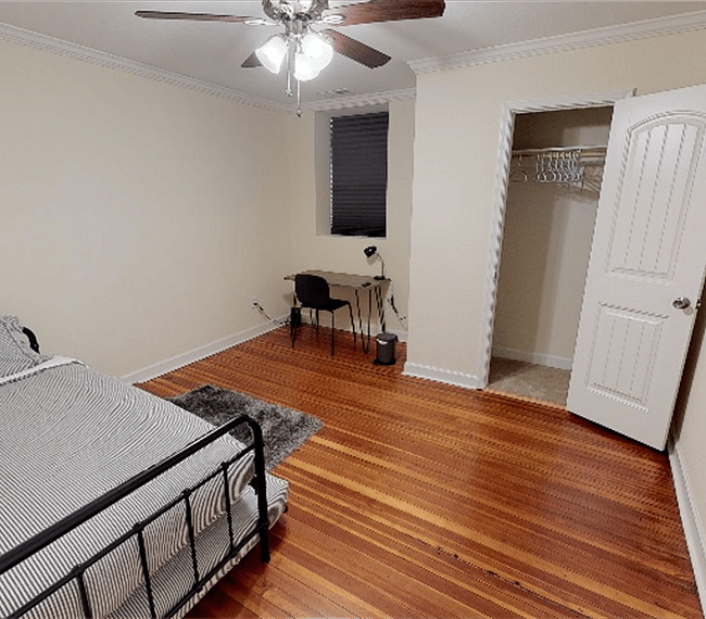 3rd bedroom with 2 single beds (1 is a trundle bed), Roku TV, closet, desk & chair.