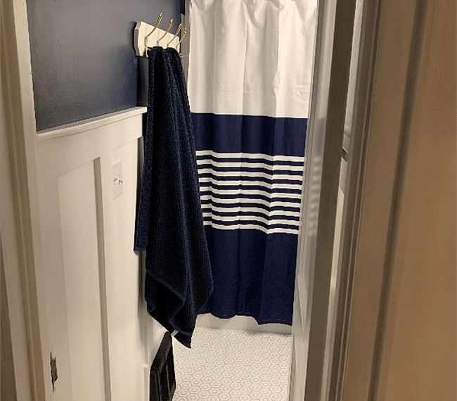 Shared bathroom with full sized tub/shower combo. 