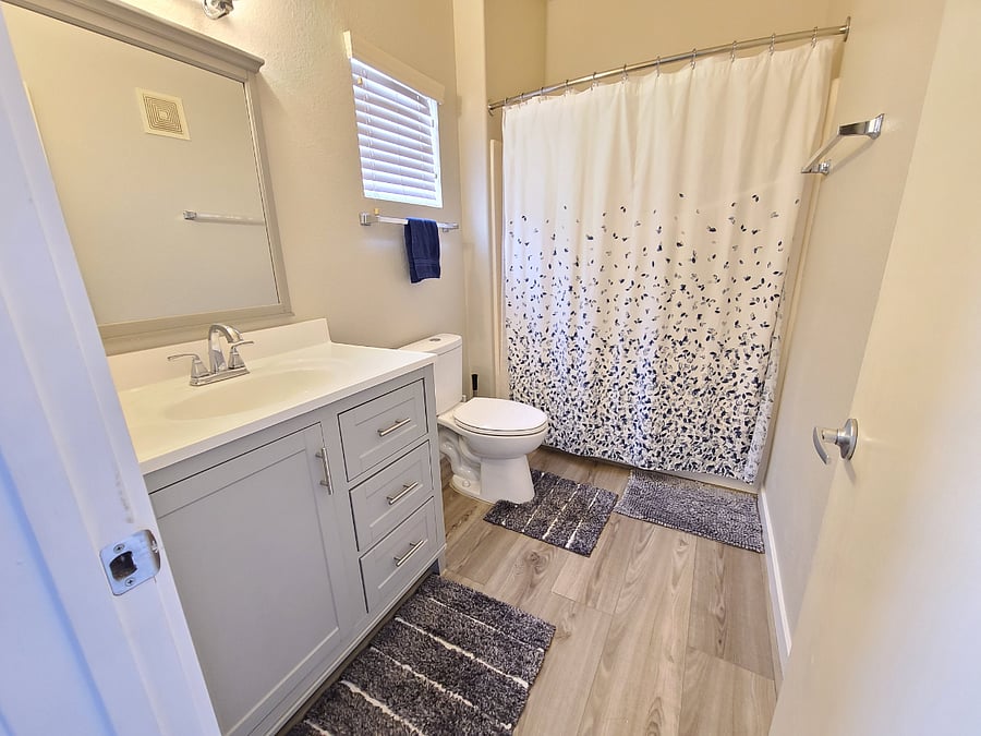 New dual flush toilet in bathroom.