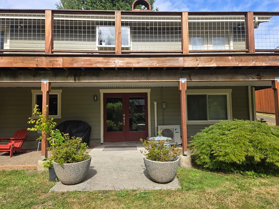 Backyard perspective showing the private entrance to the downstairs unit for easy access and privacy.