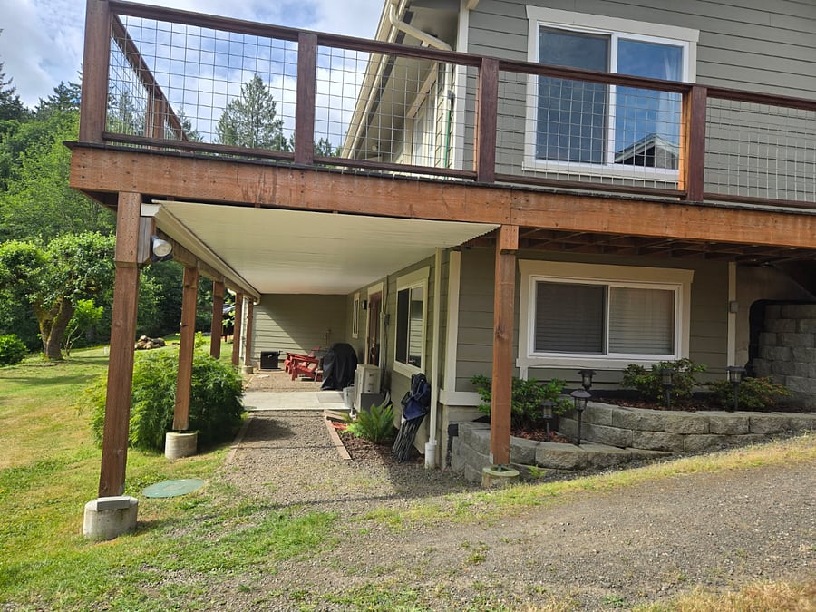 Exterior view highlighting the covered, dry area beneath which the entrance to the downstairs unit is located.