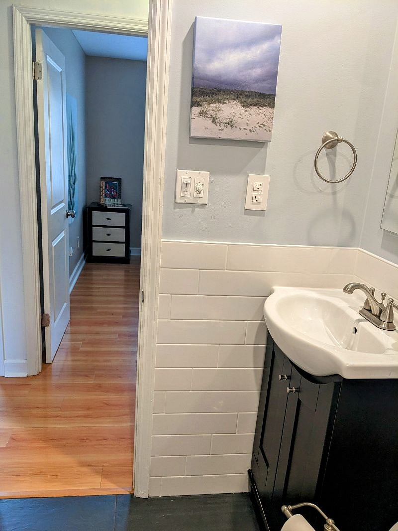 Full bath is across from the third bedroom/office. Recently redone - new tile, mirror vanity with shelves inside to store personal items