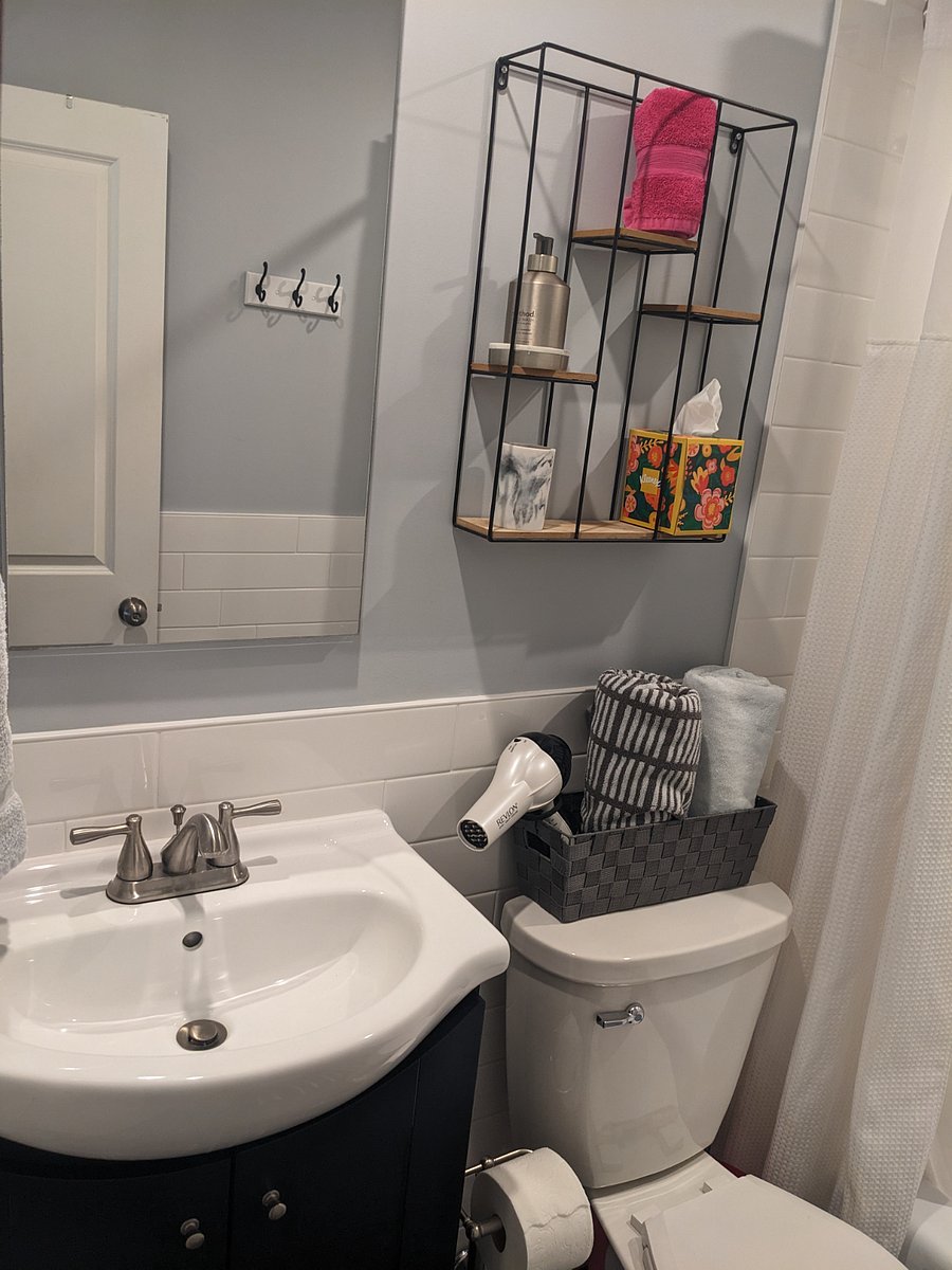 The full bath is a tub shower. Efficient. Behind the mirror is a full medicine cabinet. Please use the fan when showering.