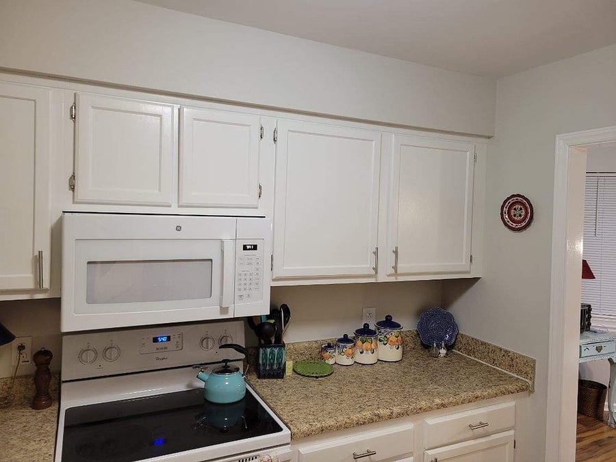 The kitchen is stocked with dishes, pots and pans and more!