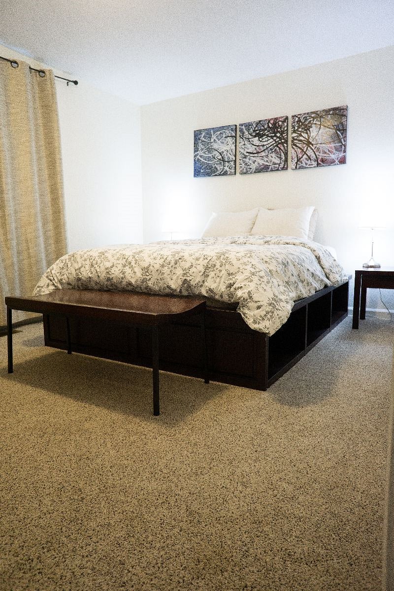 Cozy queen bed with storage underneath, 2 closets and dresser.